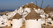 Whitewashed windmills and Churches on the top